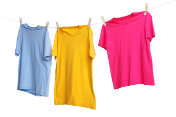 Different clothes drying while hanging on clothesline against white background