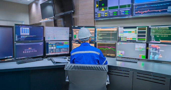 Engineer working at control room, Manager control system, Technician man monitoring program from a lot of monitor.Specialist observes analytics dashboard,operator inspects digital interface