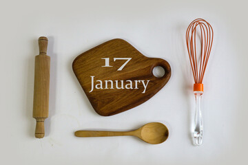 January 17th calendar: the number 17, the month name "January" in English on a wooden cutting board