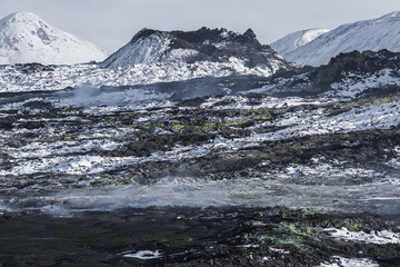 Steaming volcanic lava field in winter on Reykjanes Peninsula, Iceland.