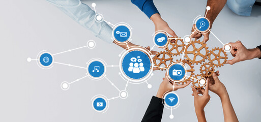 A vibrant image showcasing diverse hands working together with gear icons, symbolizing teamwork and communication in a digital and modern business environment. Amity