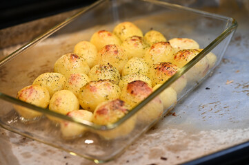 Close-up of roasted potatoes with crispy golden texture, baked vegetable dish, warm homemade comfort food, natural colors, rustic cuisine concept, food photography