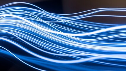 Abstract flowing blue light trails with bokeh effect representing data transfer and technology