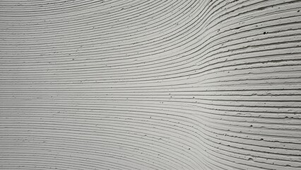 Abstract close-up of a textured grey surface with horizontal ridges and undulating wave patterns.