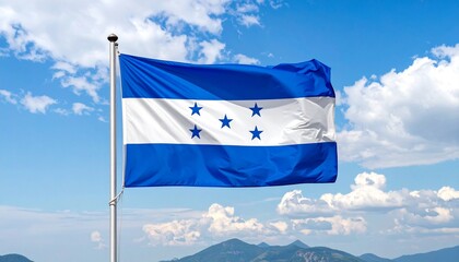 Honduran flag with five stars flying over mountains.