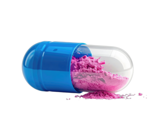 Macro shot of an open, translucent pill capsule spilling pink powder against a black background