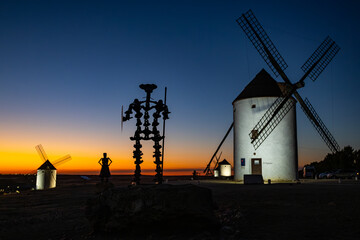 Don Quixote silhouette with windmills at Mota del Cuervo sunset