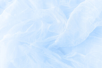 Obraz premium Soft drapery light blue tulle fabric texture background.