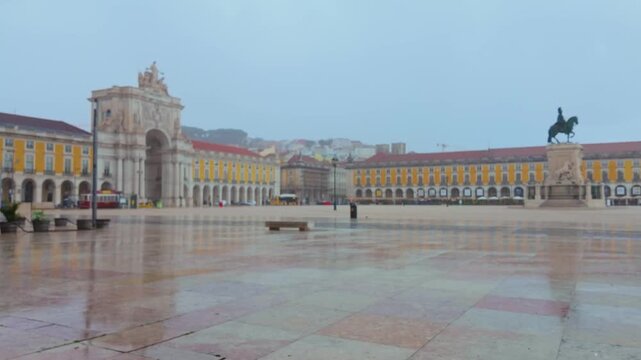 Wide shot of the main square in Lisbon on a cloudy day.