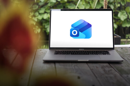 Microsoft Outlook logo shown on a MacBook Pro screen, representing a platform for email, calendar management, and workplace productivity.