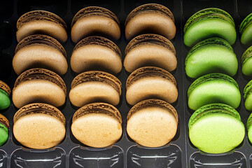 Traditional French chocolate macaroons cookies at tray