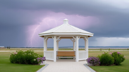 White garden gazebo on green lawn with dramatic thunderstorm sky and lightning in background weather and event risk