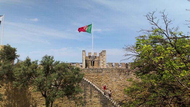 Portuguese flag waving on a castle tower.