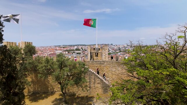 Portuguese flag waving on a castle tower.