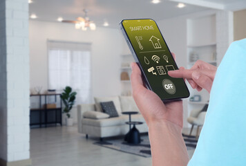 Smart home system. Woman using app on mobile phone to control house features in room, closeup