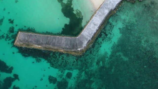 Top-down aerial view of stone pier in clear tropical sea, Philippines