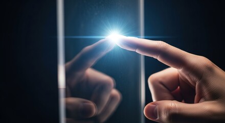 A human finger touches a glowing light on a reflective dark surface, symbolizing interaction with technology or a digital interface.