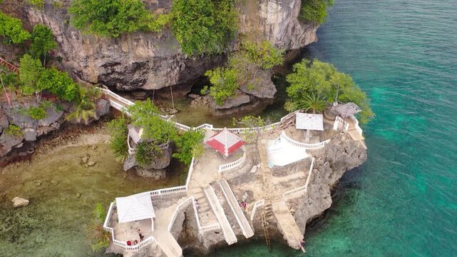 Aerial view of cliffside seaside structure above clear water, Philippi