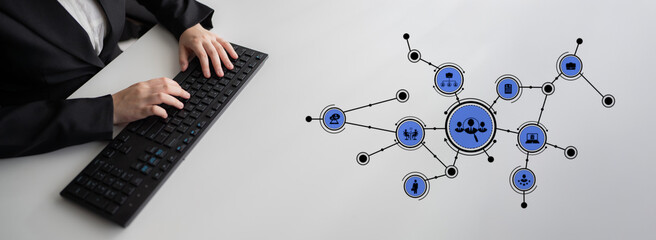 A business professional engaged in typing at a computer with a graphic overlay of network icons illustrating connectivity and modern digital interactions in a professional setting. Tessel
