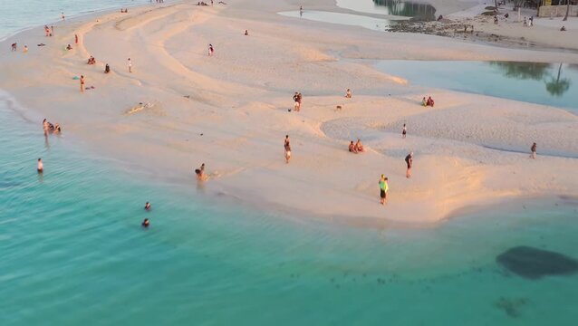 Aerial view of shallow turquoise sea with swimmers, Philippines