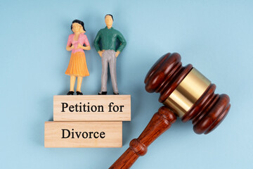 Human figurine, gavel and Petition for divorce concept on blue background