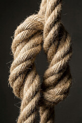 Strong natural hemp rope tied in secure knot representing teamwork and trust