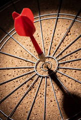 ed dart hitting exact center of cork dartboard bullseye symbolizing business success
