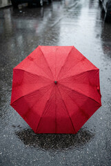 Top view of red umbrella texture with water droplets showing waterproof durability