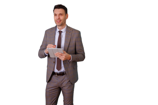 Professional businessman standing, smiling, working with a digital tablet and stylus, planning business strategy with transparent background - Powered by Adobe