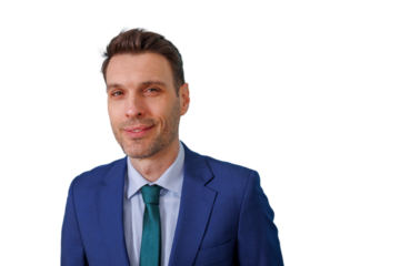 Professional man in a blue suit and green tie smiling, showing confidence and business success with transparent background