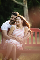 Couple sitting together on a bench in the park