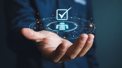 Man holding a futuristic digital HUD interface showing a person icon and a checkmark, representing a verified user or selected job candidate