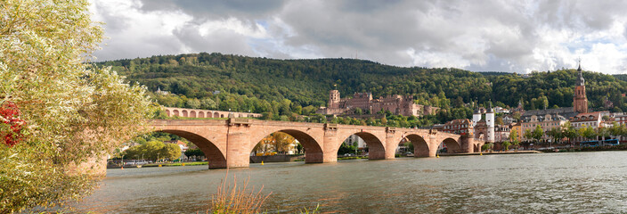 Heidelberg Germany Historic Old Bridge Neckar River and Castle Panorama.The Karl Theodor Bridge and castle on the hill. Heidelberg, Baden-Wurttemberg, Germany.

