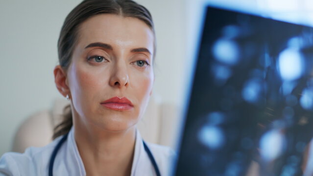 Healthcare provider reading x-ray scan at medical examination clinic closeup