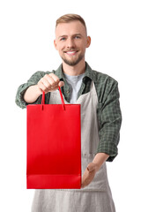 Male cashier with shopping bag on white background