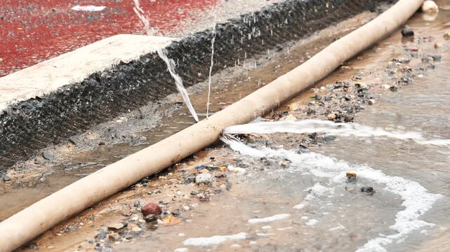 Water pipe leaking, gushing water from damaged pipeline at construction site
