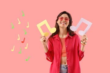 Young woman and many paper music notes on pink background