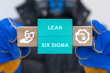 Industrial technician holding blocks with icons sees the text LEAN SIX SIGMA. Six sigma model, lean...