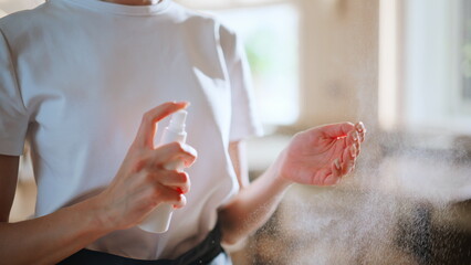 Restaurant staff sanitizing hands at light modern restaurant workplace closeup