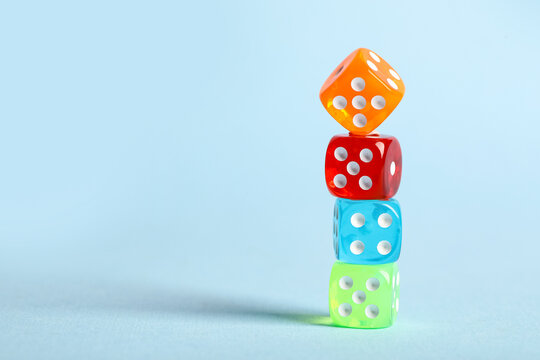 Stack of colorful game dices on blue background