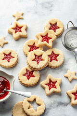 Christmas raspberry linzer cookies on white marble background. Festive dessert, winter treat