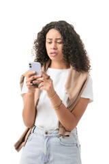 Confused young African-American woman with modern mobile phone on white background