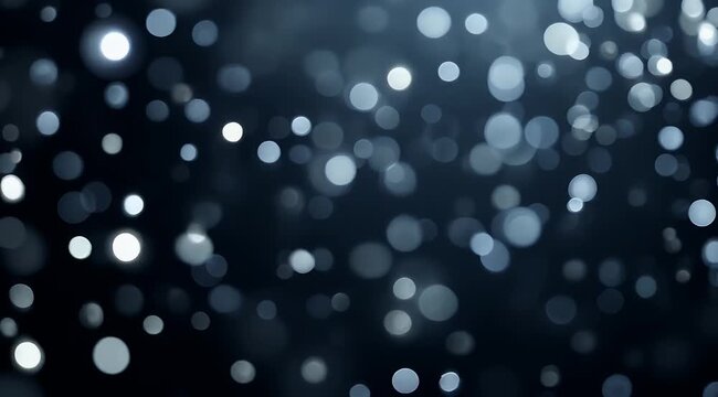 Blurred white light circles on a dark blue black background suitable for abstract backgrounds, artistic designs, and concept illustrations.