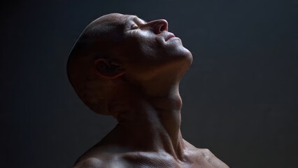 A person portrait head tilted back with eyes closed, enjoying the sensation of sunlight