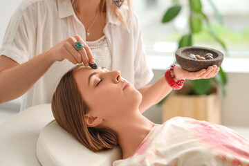 Healer working with young woman. Crystal therapy