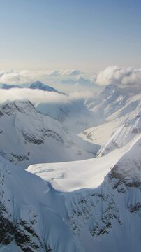 Breathtaking view of the snowy Rocky Mountains and valley on sunny day