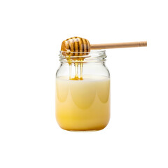 Honey dipper over jar of yellow liquid