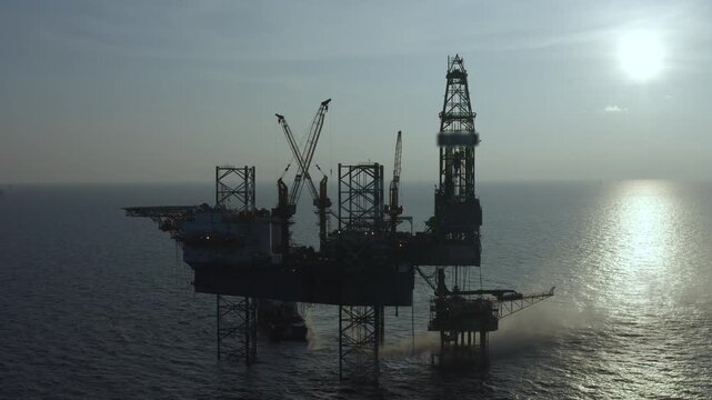 Offshore jack up rig in aerial view in the middle of the ocean taken by a drone

