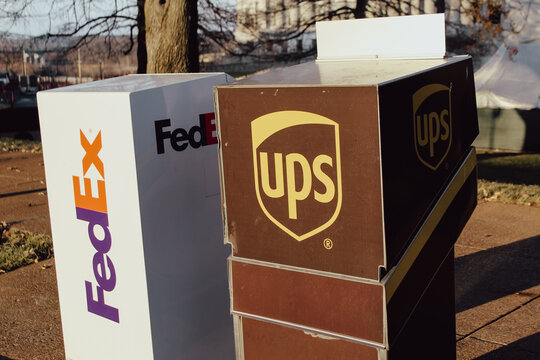 Jefferson City, MO - Dec 25, 2025: Close-up of a FedEx and UPS drop box on a sunny day. For Editorial Use Only.