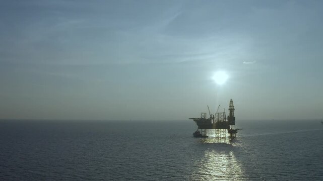 Offshore jack up rig in aerial view in the middle of the ocean taken by a drone
